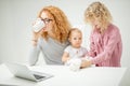 Ginger woman is drinking tea and sitting in front of the screen Royalty Free Stock Photo