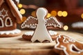 Gingerbread angel with Christmas lights and gingerbread house in the background Royalty Free Stock Photo