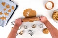 Gingerbread baking concept with gingerbread dough, flour, rolling pin and gingerbread cookies on baking tray. Royalty Free Stock Photo