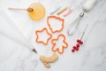 Gingerbread baking molds in the form of a man, a star and a Christmas tree. Cooking tools and ingredients on the table