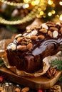 Christmas gingerbread cake covered with chocolate and decorated with nuts and almonds on the holiday table.