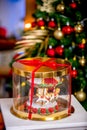 Gingerbread carousel in a gift box in front of defocused lights of Chrismtas decorated fir tree. Holiday sweets. New Year and Chri