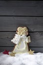 Gingerbread christmas angel star shaped decorations on heap of snow against wooden background Royalty Free Stock Photo