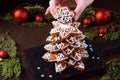 Gingerbread Christmas tree with glazing on the dark board