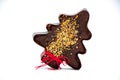 Gingerbread Christmas tree with nuts and red festive stripe on t
