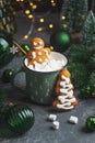 Gingerbread Cookie Man into Christmas Mug with Marshmallows and Festive Decor Royalty Free Stock Photo