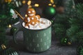 Gingerbread Cookie Man into Christmas Mug with Marshmallows and Festive Decor Royalty Free Stock Photo