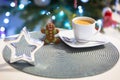 Gingerbread cookie man at the cup of hot coffee and christmas tree lights in background Royalty Free Stock Photo