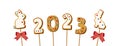 Gingerbread cookie numerals 2023 and bunny on sticks in cartoon style. Sweet biscuit number and rabbit in new year