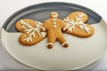 Gingerbread cookie in the shape of hearts and a man on a white-black plate Royalty Free Stock Photo