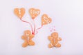 Gingerbread cookies couple for Valentines Day. Man with balloons in the shape of hearts with letteing I Love You and woman on the