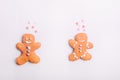 Gingerbread cookies couple for Valentines Day. Man and woman with emotions in the shape of hearts on the white background. Love an Royalty Free Stock Photo