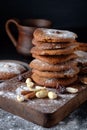 Gingerbread cookies dusted with icing sugar on a wooden table