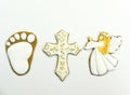 Gingerbread cookies in the form of a baby`s heel, a cross and an angel on a white background Royalty Free Stock Photo