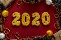 Gingerbread cookies in the form of numbers 2020, gifts christmas or Noel holiday, Happy New Year, red background, horizontal Royalty Free Stock Photo