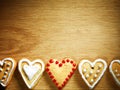 Gingerbread cookies hanging over wooden background