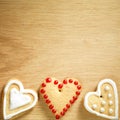 Gingerbread cookies hanging over wooden background