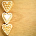 Gingerbread cookies hanging over wooden background