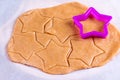 Gingerbread cookies in the making on wooden cutting board pastry raw dough star shape cutters Royalty Free Stock Photo