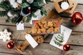 Gingerbread cookies. Rustic style Christmas table decoration with wooden planks and red Christmas balls. Top view Royalty Free Stock Photo