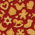 Gingerbread cookies seamless pattern on red knitting background. Festive sweet biscuits in shape of man, snowflake and Royalty Free Stock Photo