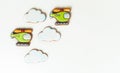 Gingerbread cookies in the shape of military helicopters flying in the clouds. Army or Men`s day. Flat lay on white
