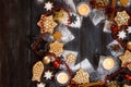 Gingerbread cookies, spices and burning candles on a star shape from icing sugar on a dark rustic wooden background, Christmas Royalty Free Stock Photo