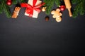 Gingerbread cookies, spices and Christmas decorations at black. Royalty Free Stock Photo