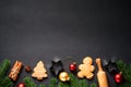 Gingerbread cookies, spices and Christmas decorations at black. Royalty Free Stock Photo