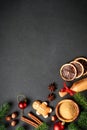 Gingerbread cookies, spices and Christmas decorations at black. Royalty Free Stock Photo