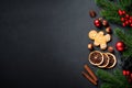 Gingerbread cookies, spices and Christmas decorations at black. Royalty Free Stock Photo
