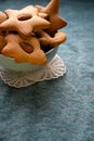 Gingerbread cookies of star and Christmas trees shaped in a bowl on a blue table Royalty Free Stock Photo