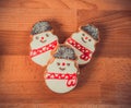 Gingerbread cookies on wood background.Snowman, deer, fir-tree, boot, Santa Claus, mitten.