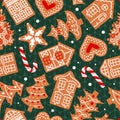 Gingerbread, decorated with icing, lie on a green knitted sweater. Christmas seamless pattern. Traditional cookies. Houses, candy