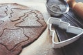 Gingerbread dough, rolled out with different Christmas shapes cut into it and sprinkled with powdered sugar Royalty Free Stock Photo