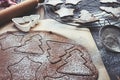 Gingerbread dough, rolled out with different Christmas shapes cut into it and sprinkled with powdered sugar Royalty Free Stock Photo