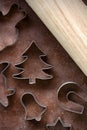 Gingerbread dough rolled out, wooden rolling pin and various shapes of metal Christmas cookies cutters Royalty Free Stock Photo