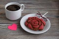 Gingerbread in the form of a flower of a red rose, paper in the form of pink heart and a cup with coffee Royalty Free Stock Photo