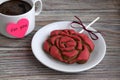 Gingerbread in the form of a rose flower. Cup with coffee. Heart from paper with an inscription Royalty Free Stock Photo