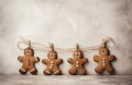 Gingerbread gingerbread hanging from a string as Christmas decorations on a concrete wooden background. AI-Generated