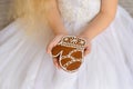 Gingerbread in the girl`s hands in a white magnificent dress
