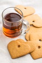 Gingerbread heart shape and cup of tea. Royalty Free Stock Photo