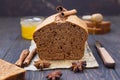 Gingerbread and honey loaf cake with cinnamon and anise on dark wooden background. Rustic style