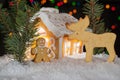 Gingerbread house with gingerbread man, elk and christmas trees. Royalty Free Stock Photo