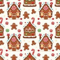 Gingerbread houses and cookies are arranged in a repeating festive pattern with candy canes peppermints and snowflakes on a light Royalty Free Stock Photo