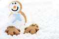 Gingerbread kids play with snowman on snow