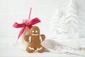 Gingerbread man and bottle of milk with straw on a white wooden background with Christmas trees Royalty Free Stock Photo
