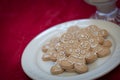 Gingerbread Man Cookes On Plate with Milk Resting on Red Table Cloth