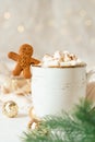 Gingerbread man cookie in cup of hot cocoa or coffee with marshmallow, fir tree, cinnamon and warm cozy sweater Royalty Free Stock Photo