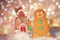 Gingerbread man cookie standing beside house Royalty Free Stock Photo